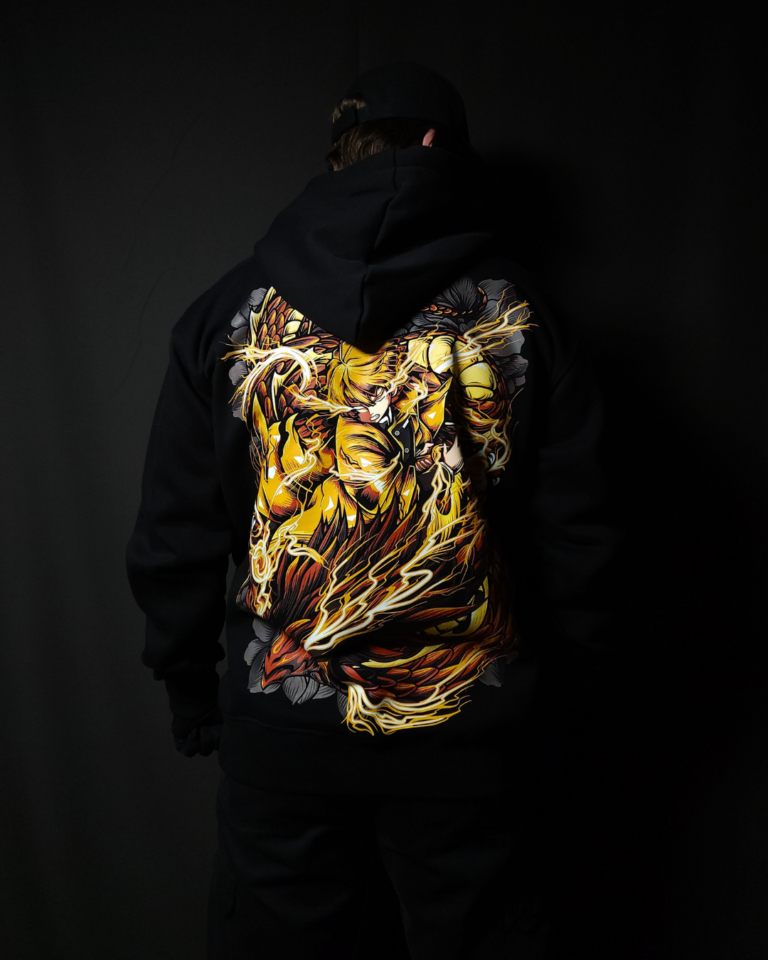 Anime-inspired apparel featuring bold back artwork, worn by a model in a dark studio setting – from a South African anime clothing brand.