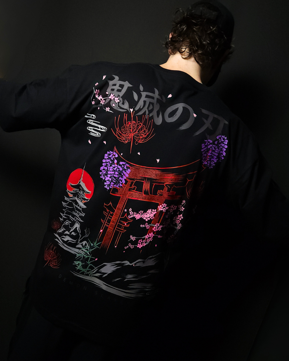 Anime-inspired apparel featuring bold back artwork, worn by a model in a dark studio setting – from a South African anime clothing brand.