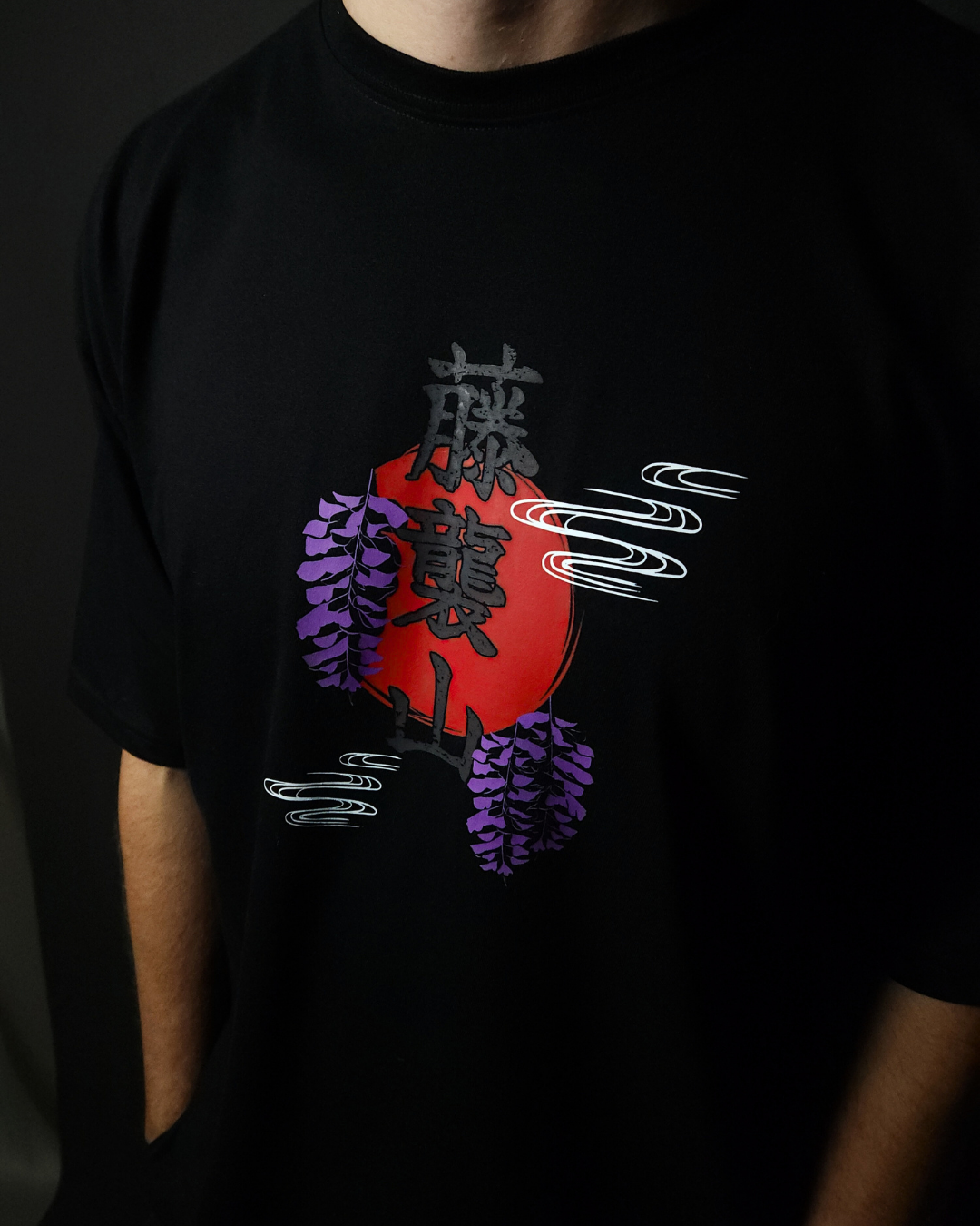 Anime-inspired apparel featuring bold back artwork, worn by a model in a dark studio setting – from a South African anime clothing brand.