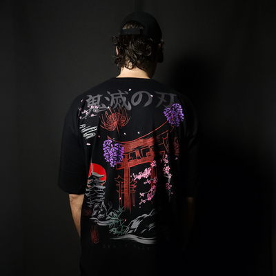 Anime-inspired apparel featuring bold back artwork, worn by a model in a dark studio setting – from a South African anime clothing brand.