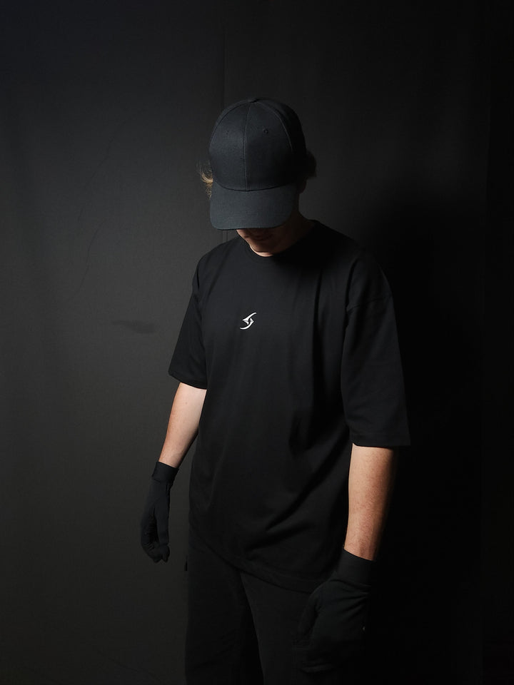 Anime-inspired apparel featuring bold back artwork, worn by a model in a dark studio setting – from a South African anime clothing brand.