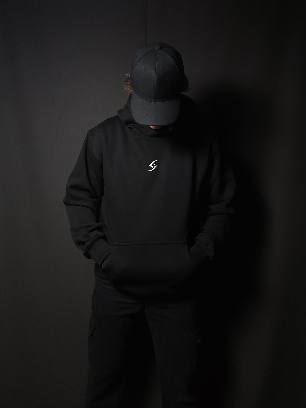 Anime-inspired apparel featuring bold back artwork, worn by a model in a dark studio setting – from a South African anime clothing brand.
