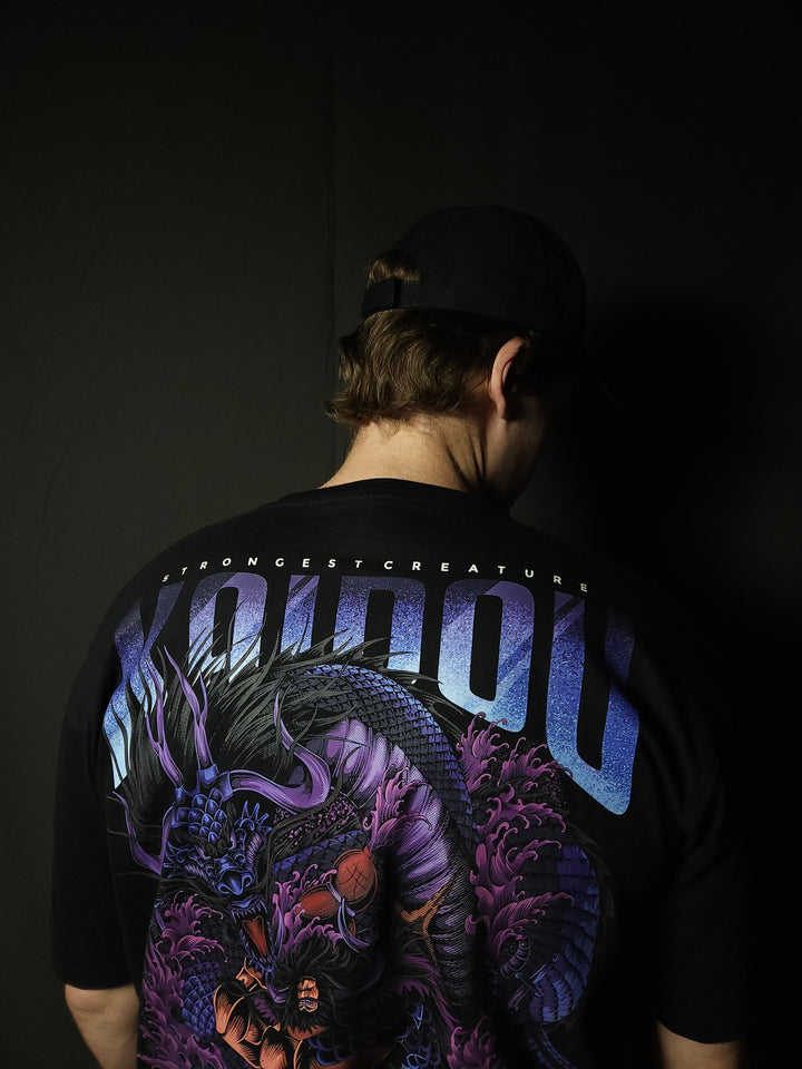 Anime-inspired apparel featuring bold back artwork, worn by a model in a dark studio setting – from a South African anime clothing brand.
