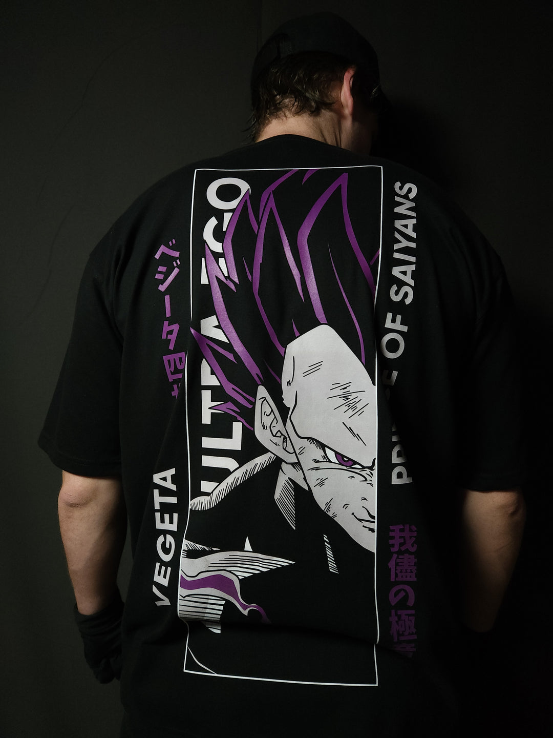 Anime-inspired apparel featuring bold back artwork, worn by a model in a dark studio setting – from a South African anime clothing brand.