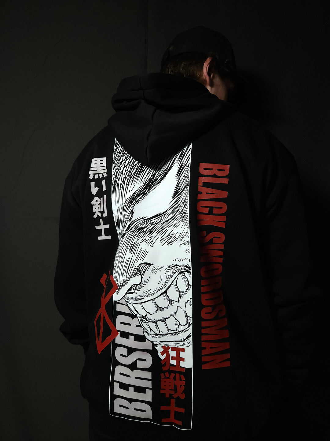 Anime-inspired apparel featuring bold back artwork, worn by a model in a dark studio setting – from a South African anime clothing brand.