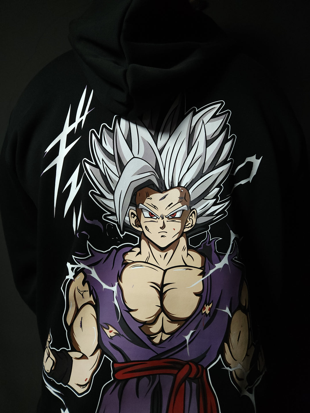 Anime-inspired apparel featuring bold back artwork, worn by a model in a dark studio setting – from a South African anime clothing brand.