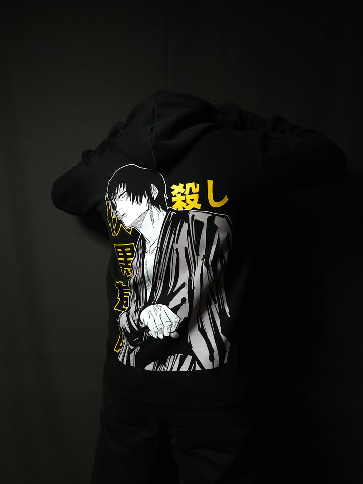 Anime-inspired apparel featuring bold back artwork, worn by a model in a dark studio setting – from a South African anime clothing brand.