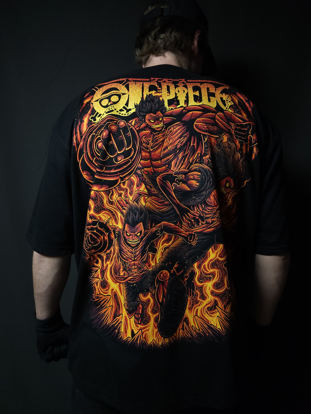 Anime-inspired apparel featuring bold back artwork, worn by a model in a dark studio setting – from a South African anime clothing brand.