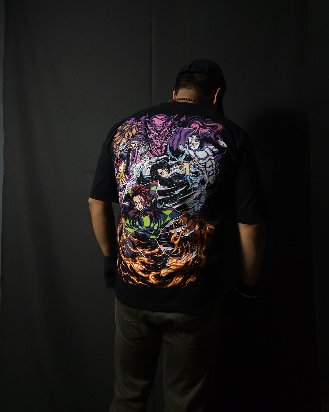Anime-inspired apparel featuring bold back artwork, worn by a model in a dark studio setting – from a South African anime clothing brand.