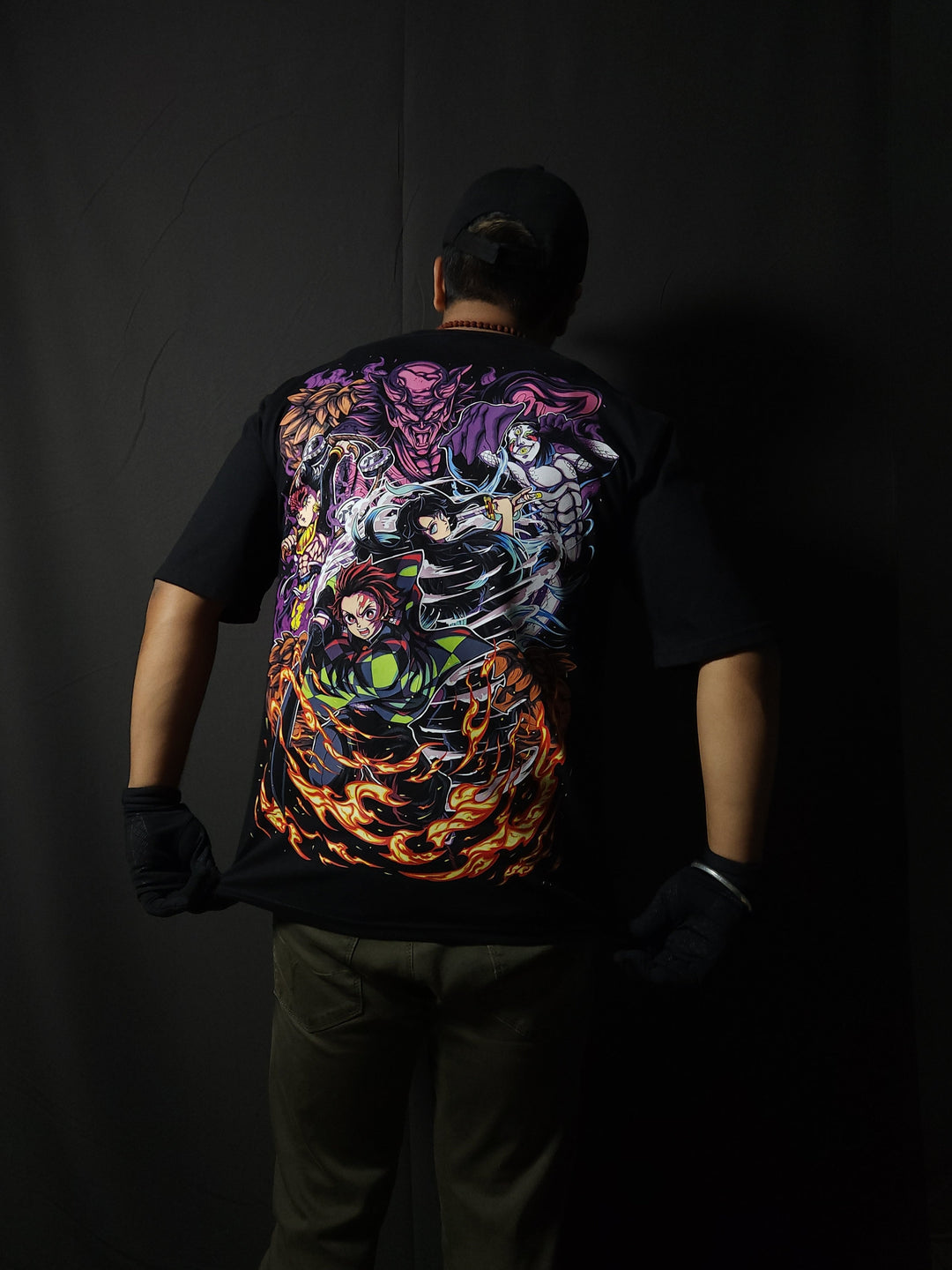 Anime-inspired apparel featuring bold back artwork, worn by a model in a dark studio setting – from a South African anime clothing brand.