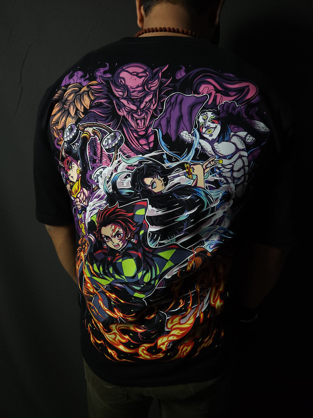 Anime-inspired apparel featuring bold back artwork, worn by a model in a dark studio setting – from a South African anime clothing brand.