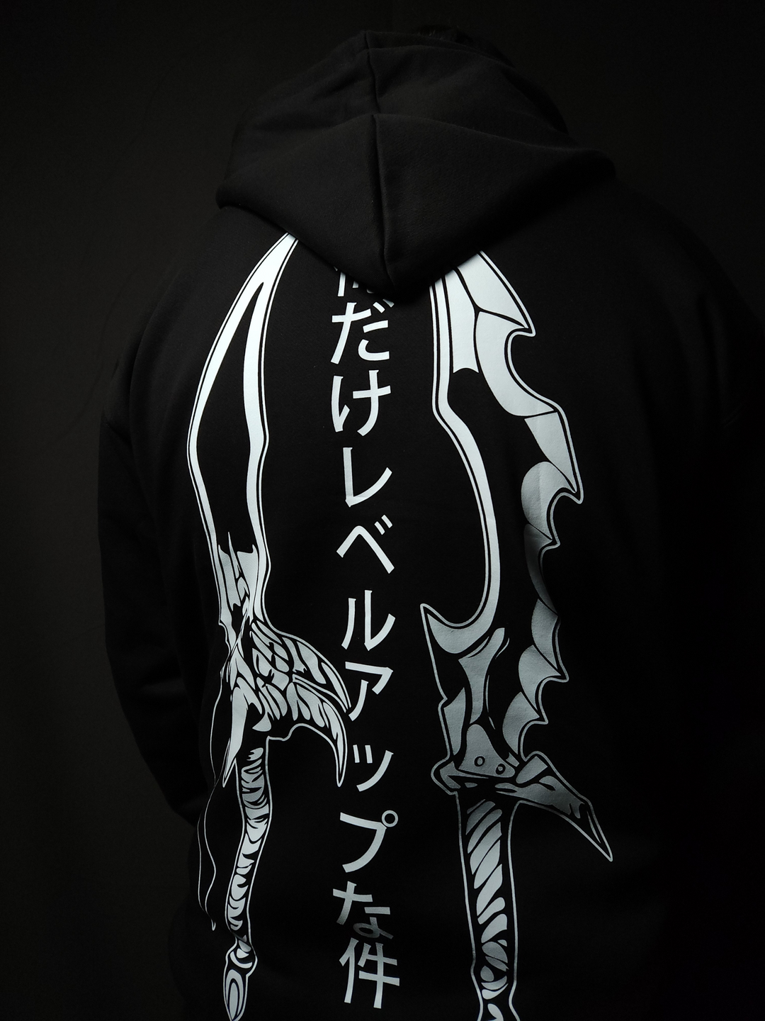 Anime-inspired apparel featuring bold back artwork, worn by a model in a dark studio setting – from a South African anime clothing brand.