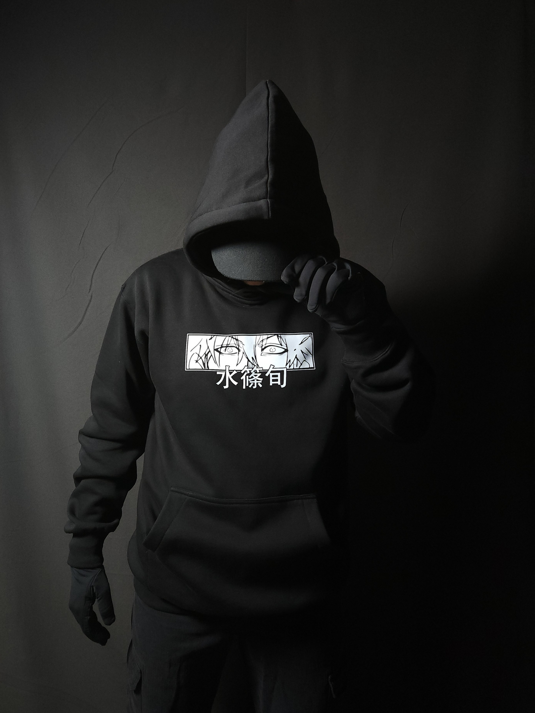 Anime-inspired apparel featuring bold back artwork, worn by a model in a dark studio setting – from a South African anime clothing brand.