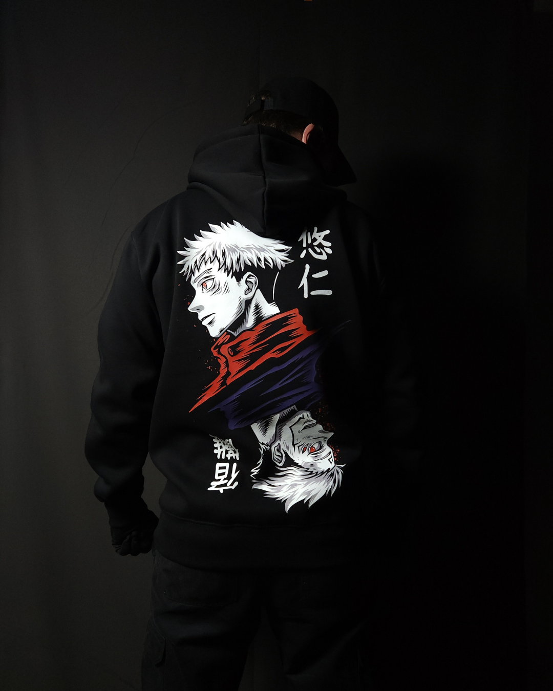 Anime-inspired apparel featuring bold back artwork, worn by a model in a dark studio setting – from a South African anime clothing brand.