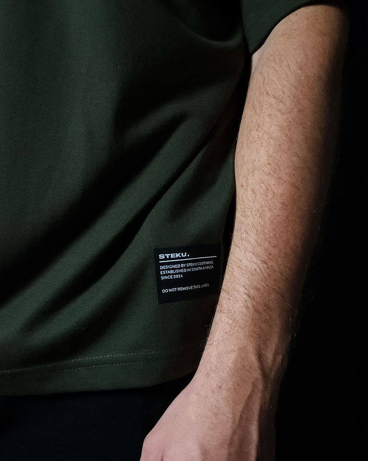 Anime-inspired apparel featuring bold Naruto back artwork, worn by a model in a dark studio setting – from a South African anime clothing brand.