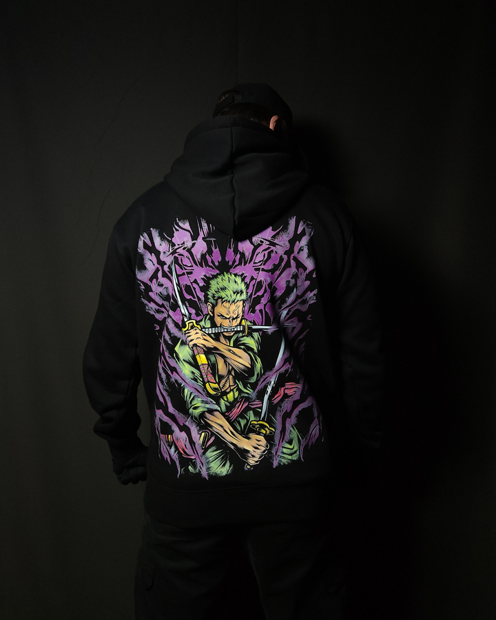 Anime-inspired apparel featuring bold back artwork, worn by a model in a dark studio setting – from a South African anime clothing brand.