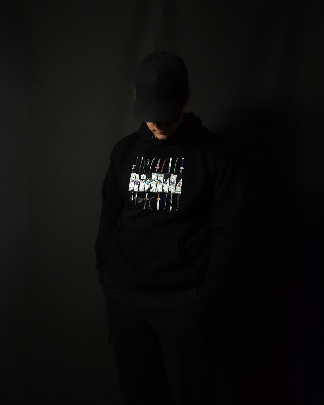 Anime-inspired apparel featuring bold back artwork, worn by a model in a dark studio setting – from a South African anime clothing brand.
